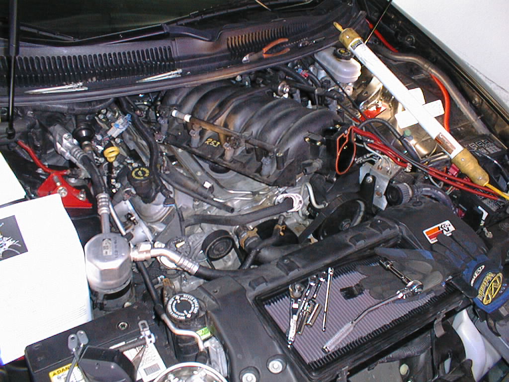 Remove the 4 remaining bolts holding the fuel rail to the intake manifold.